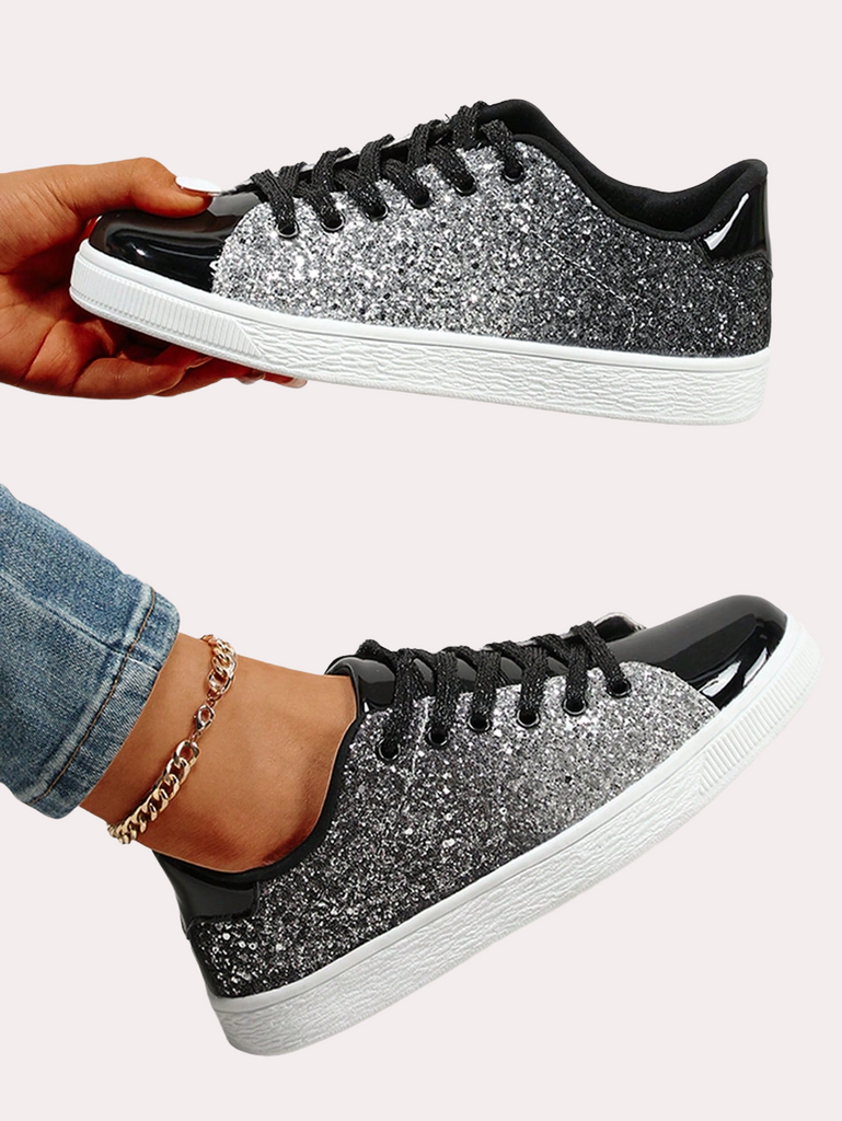 a pair of black and white sneakers with silver glitter