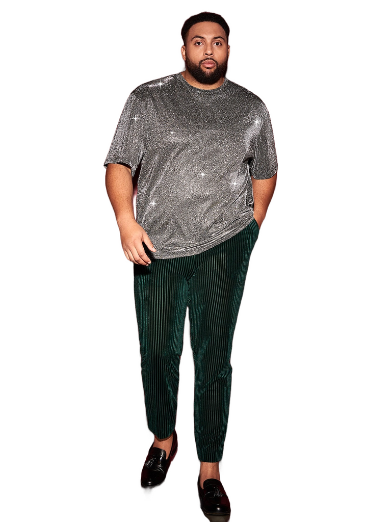 a man in a silver shirt and green pants
