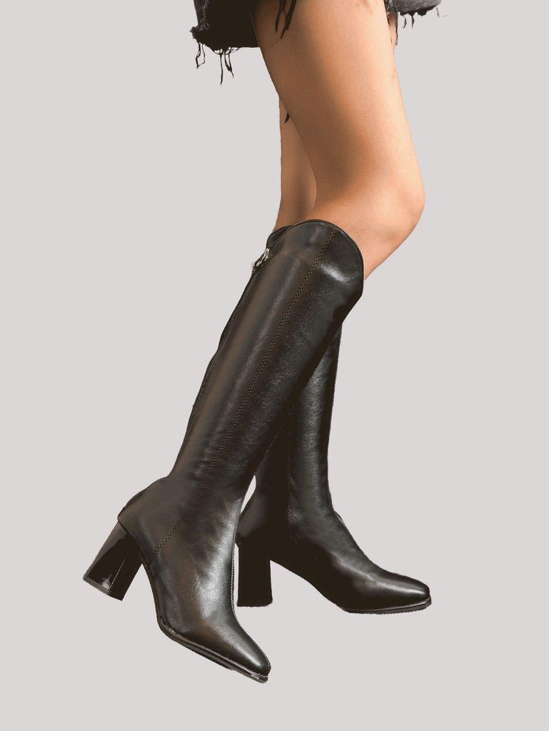 a woman's legs in high heel boots