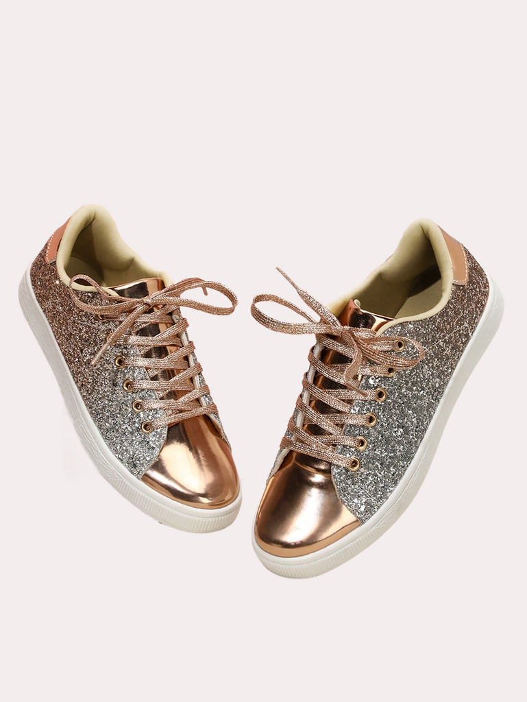a pair of gold and silver sneakers on a white background
